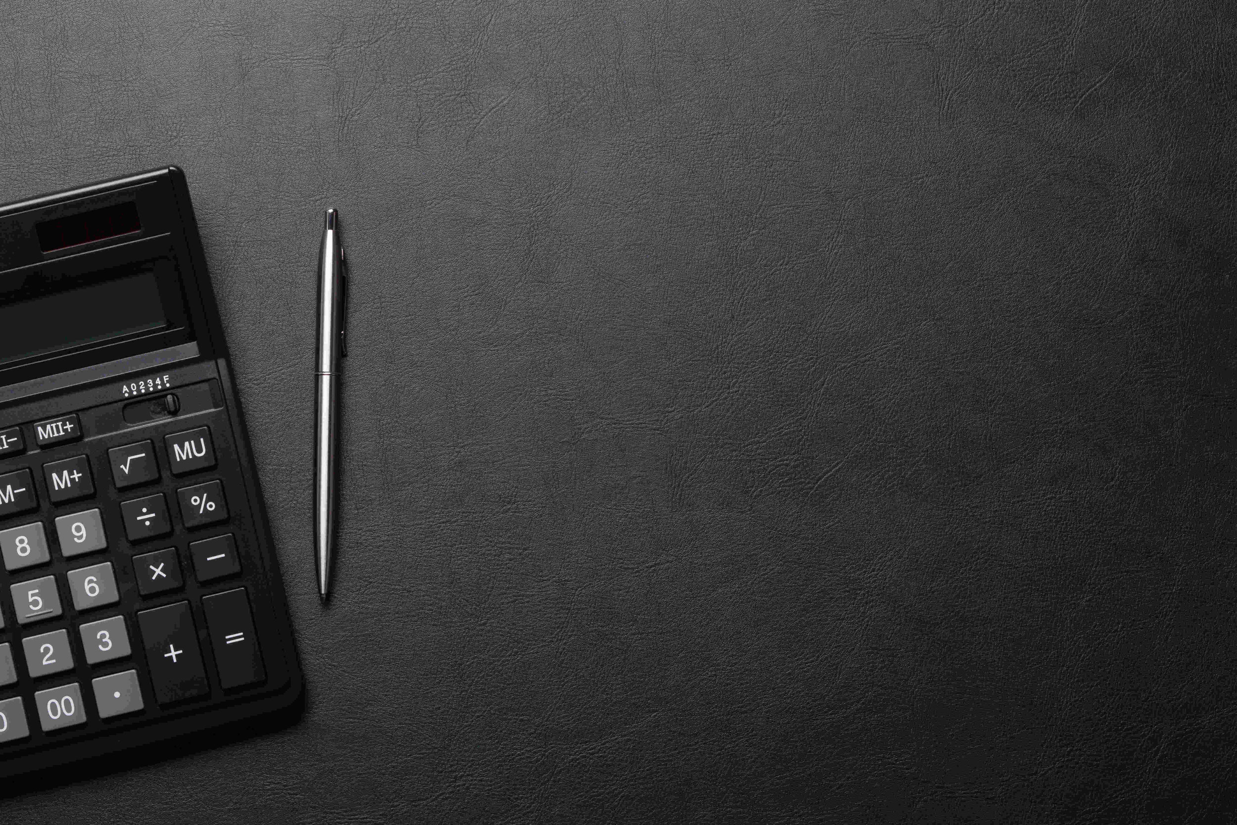 calculator-on-gray-background-with-pen.jpg